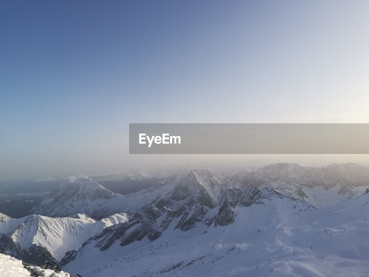 Scenic view of snow covered mountains against sky