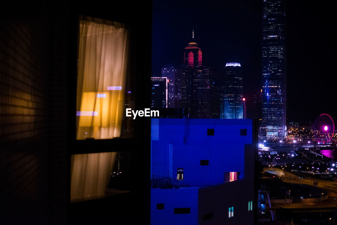 ILLUMINATED BUILDINGS AGAINST SKY AT NIGHT