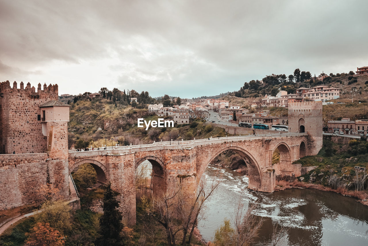 Old arched bridge crossing a river in toledo city.