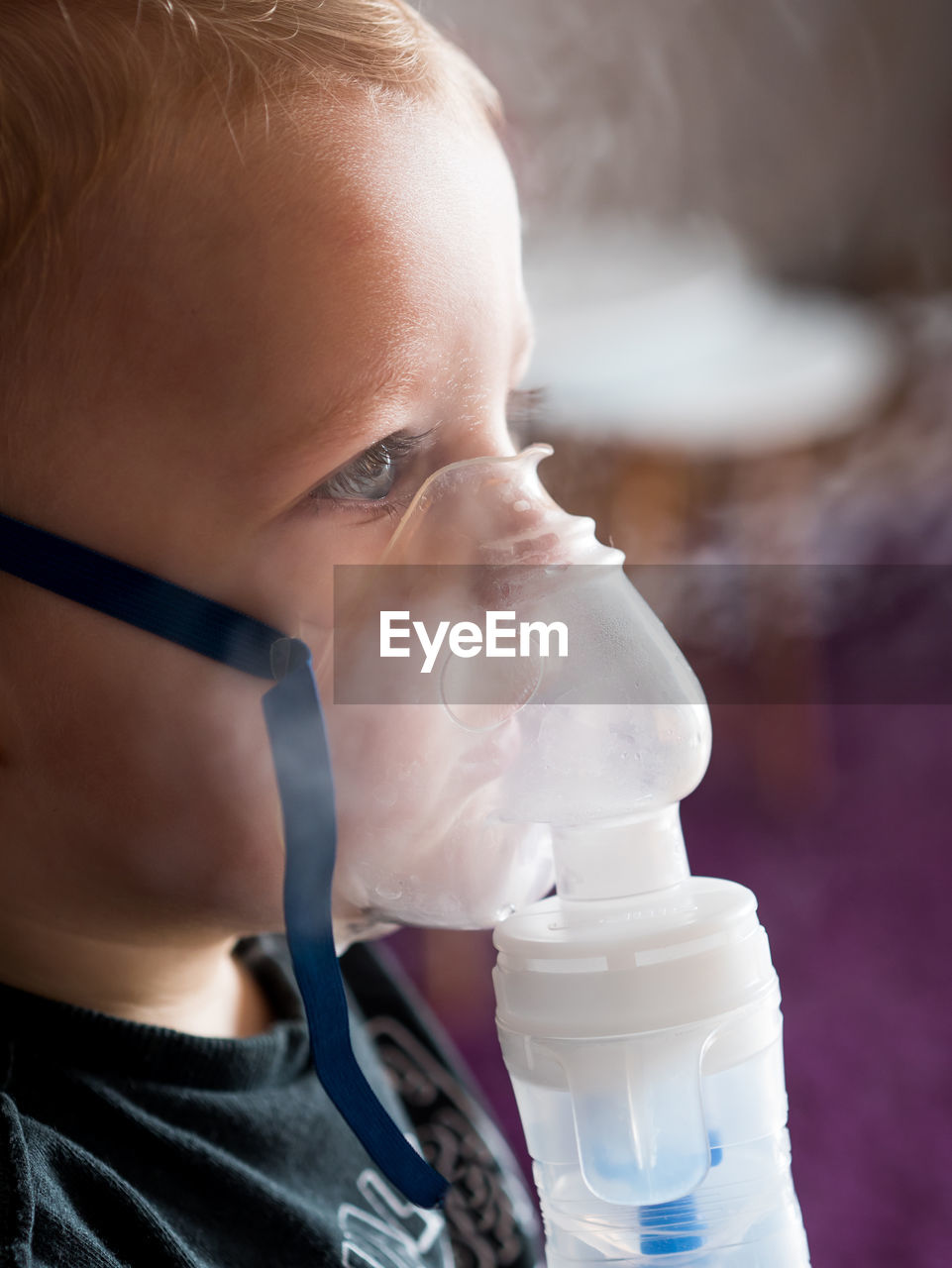 CLOSE-UP OF BOY DRINKING WATER FROM GLASS