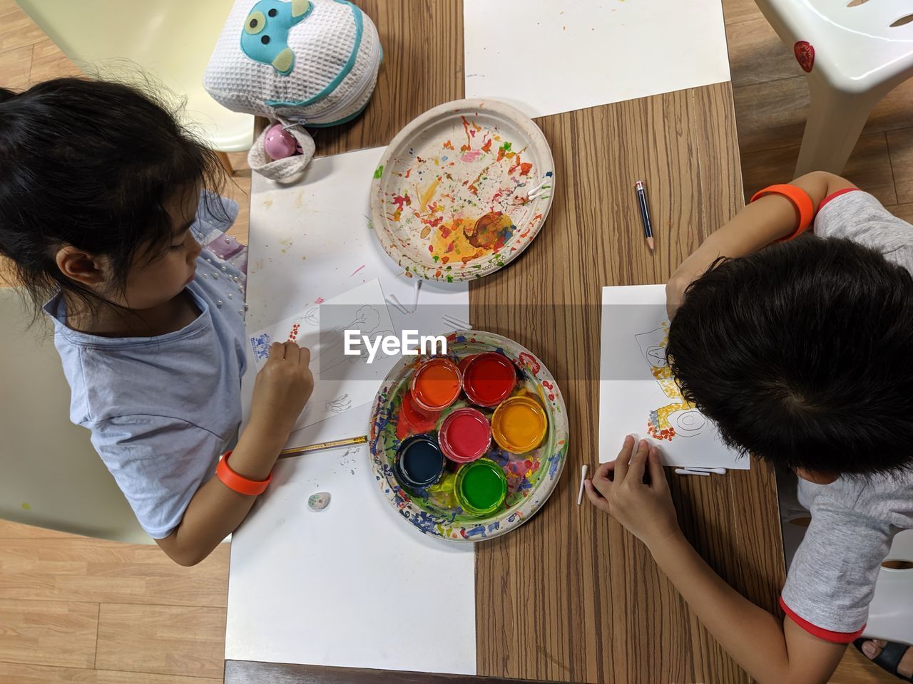 High angle view of children painting on table at home