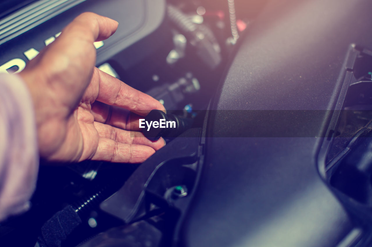 Cropped hand of man repairing car