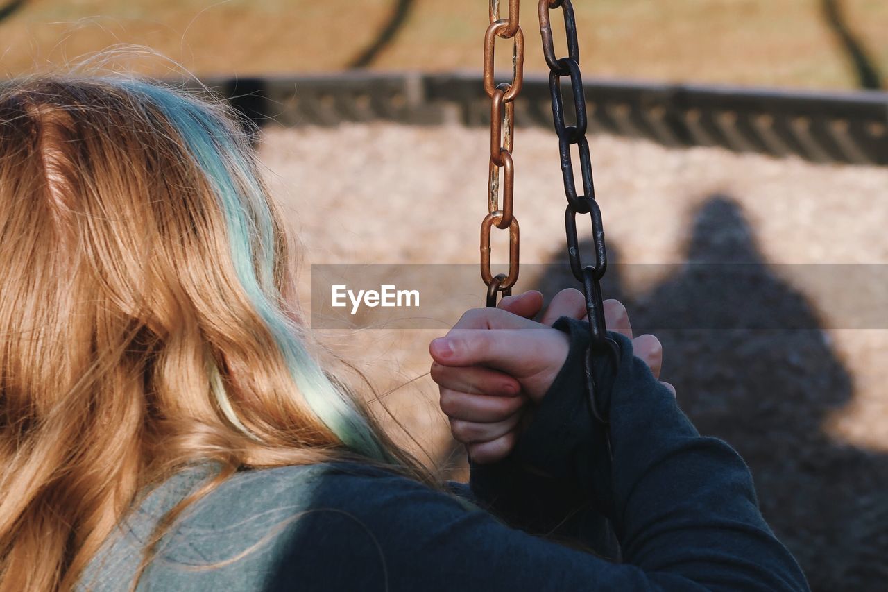 Woman holding swing in playground