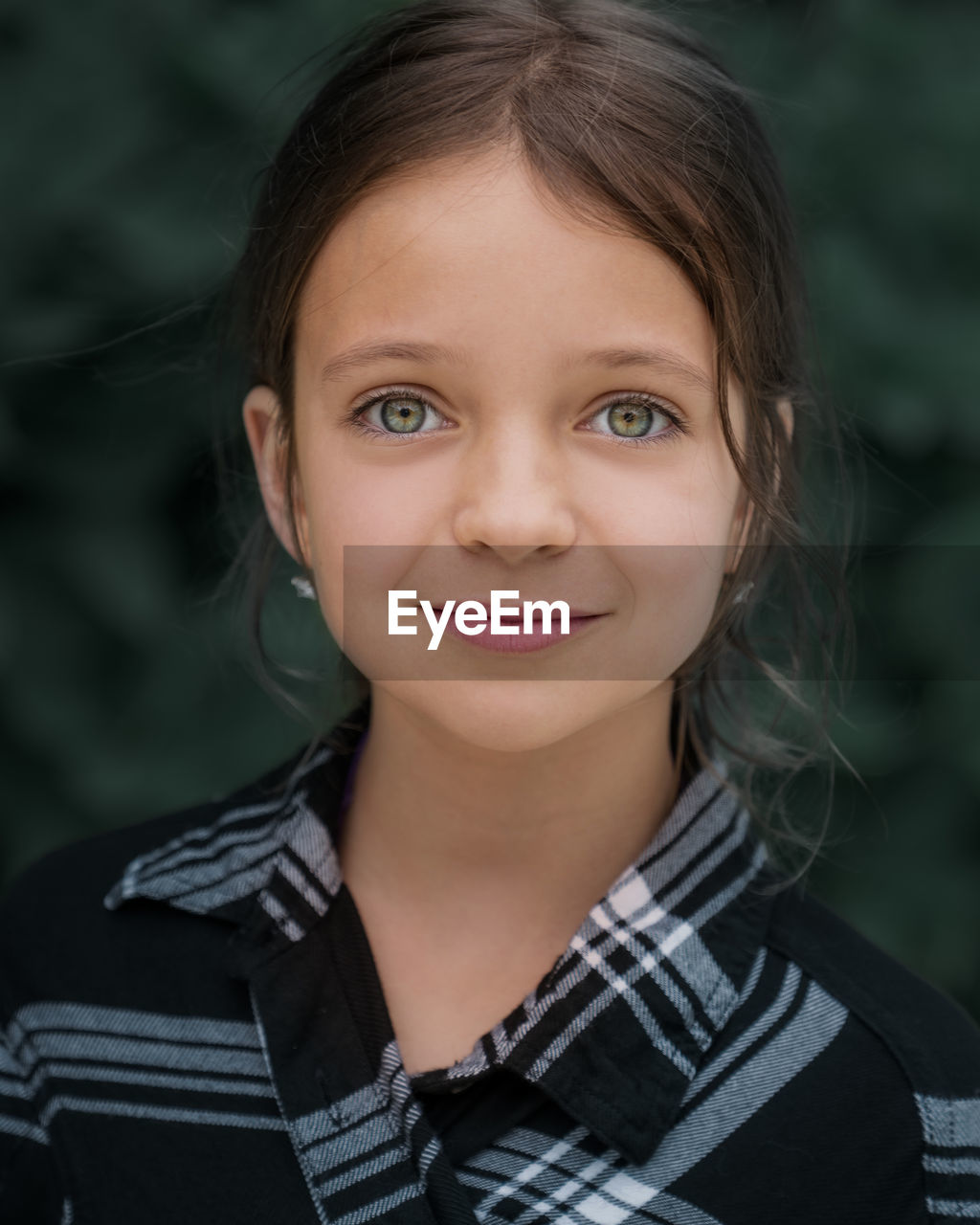 Close-up portrait of cute girl standing outdoors