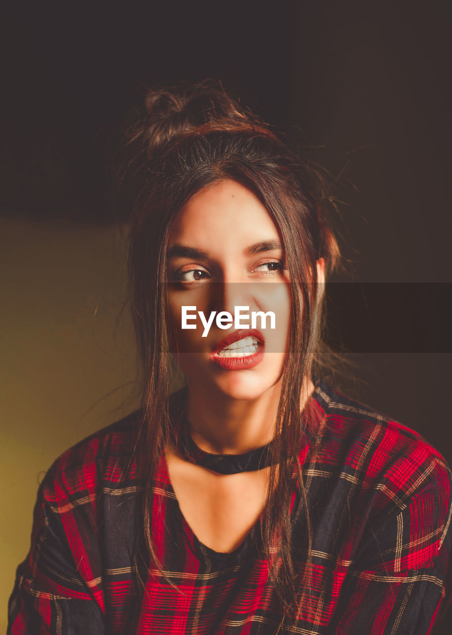 Beautiful woman making face sitting at home