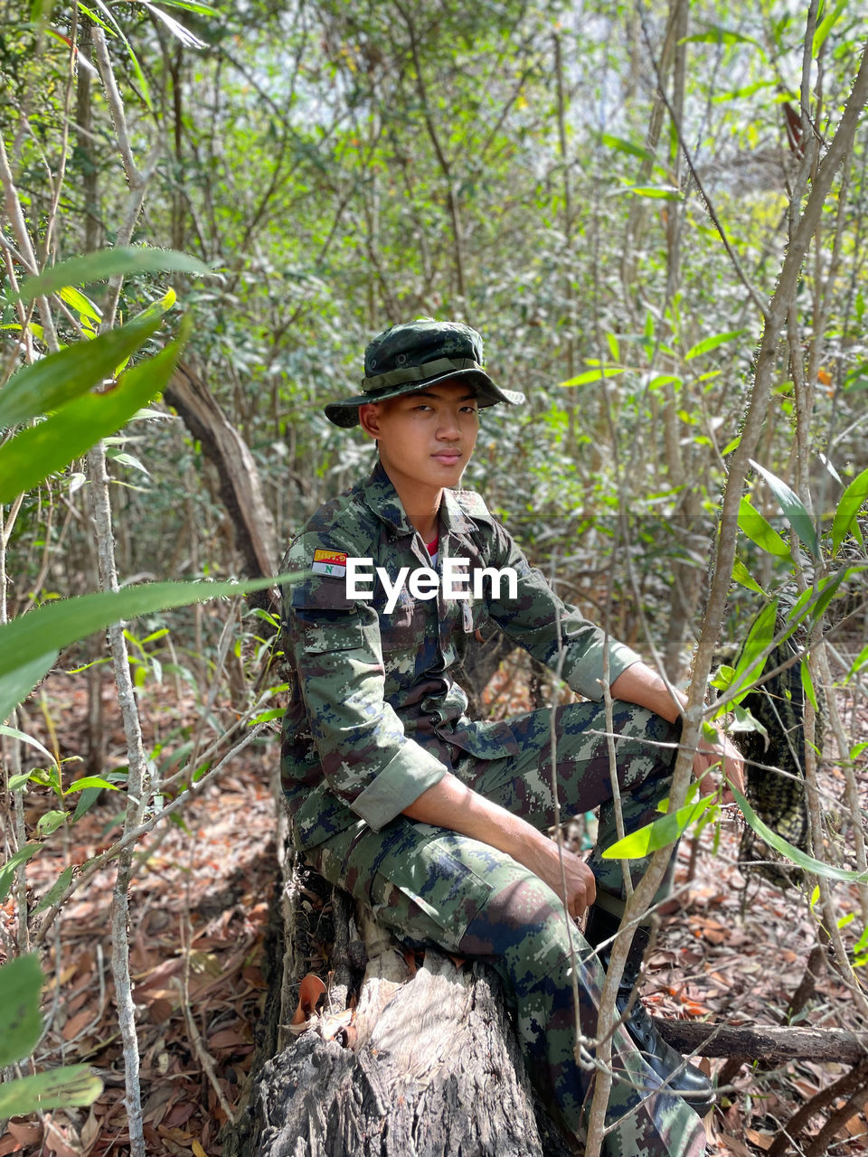 Portrait of man standing in forest