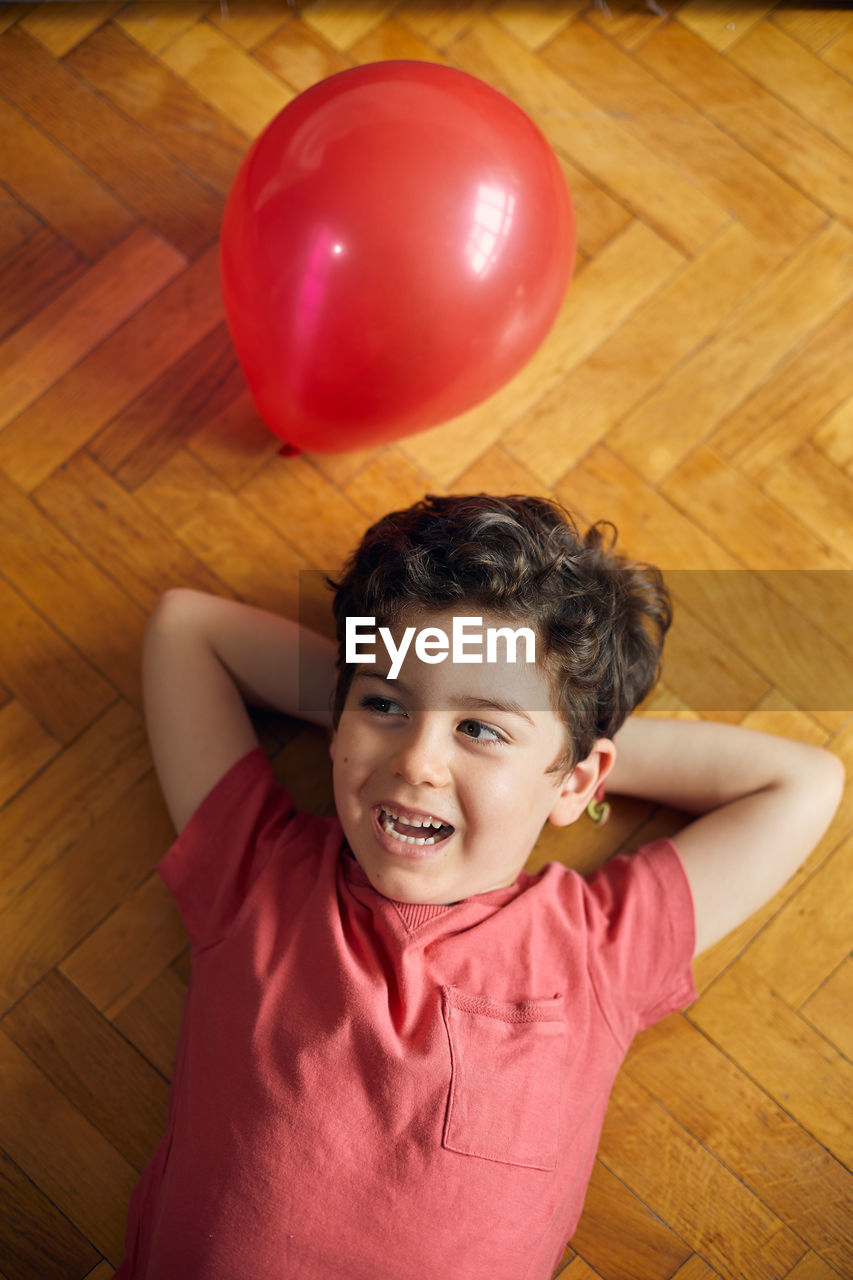 Loving moment of happy boy with his ballon