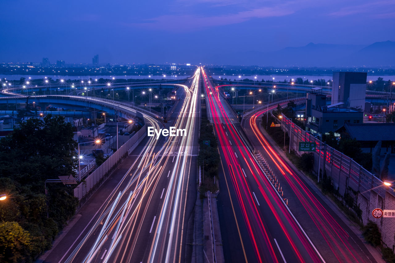 High angle view of light trails on the highway at night