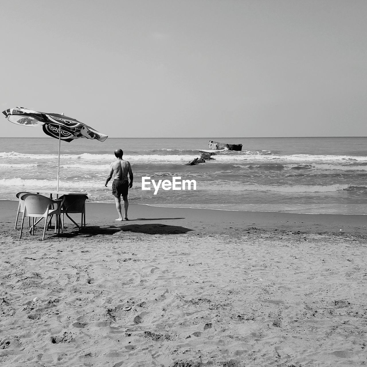 Man standing on shore at beach