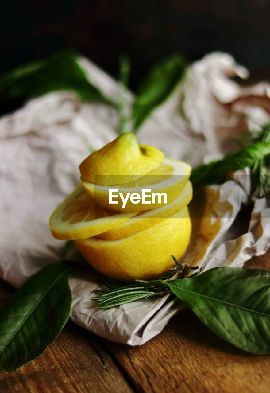 Close-up of lemon slices and leaves on paper bag