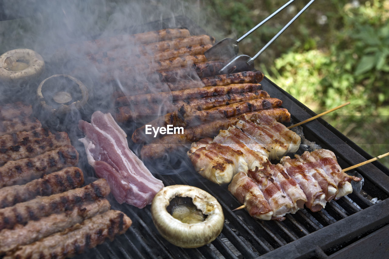 Preparing barbecue meat at picnic in nature. the meat is roasted in a conventional way.