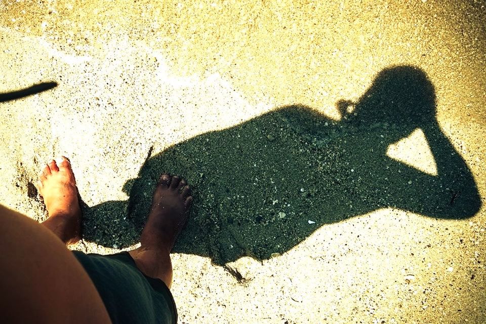 WOMAN STANDING ON BEACH