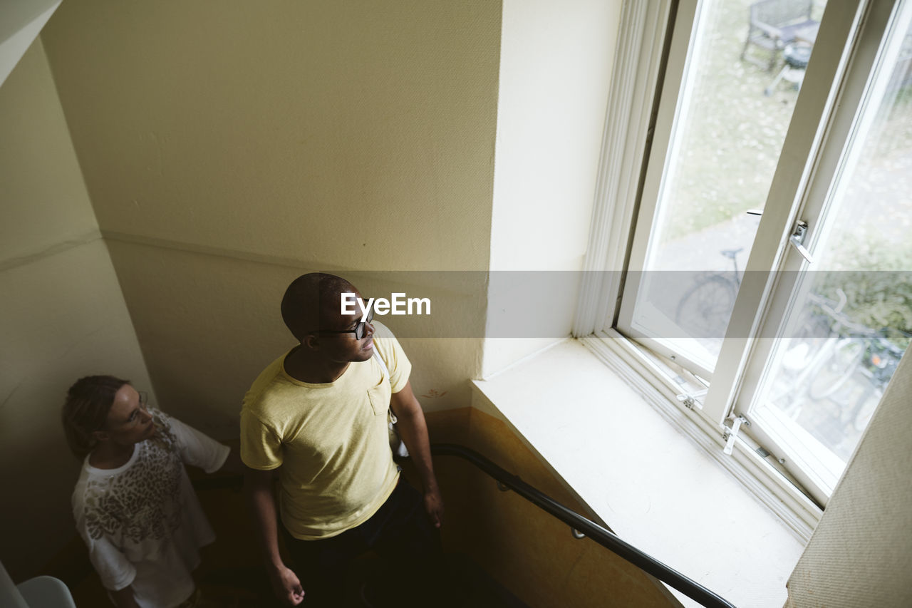 Couple looking through window