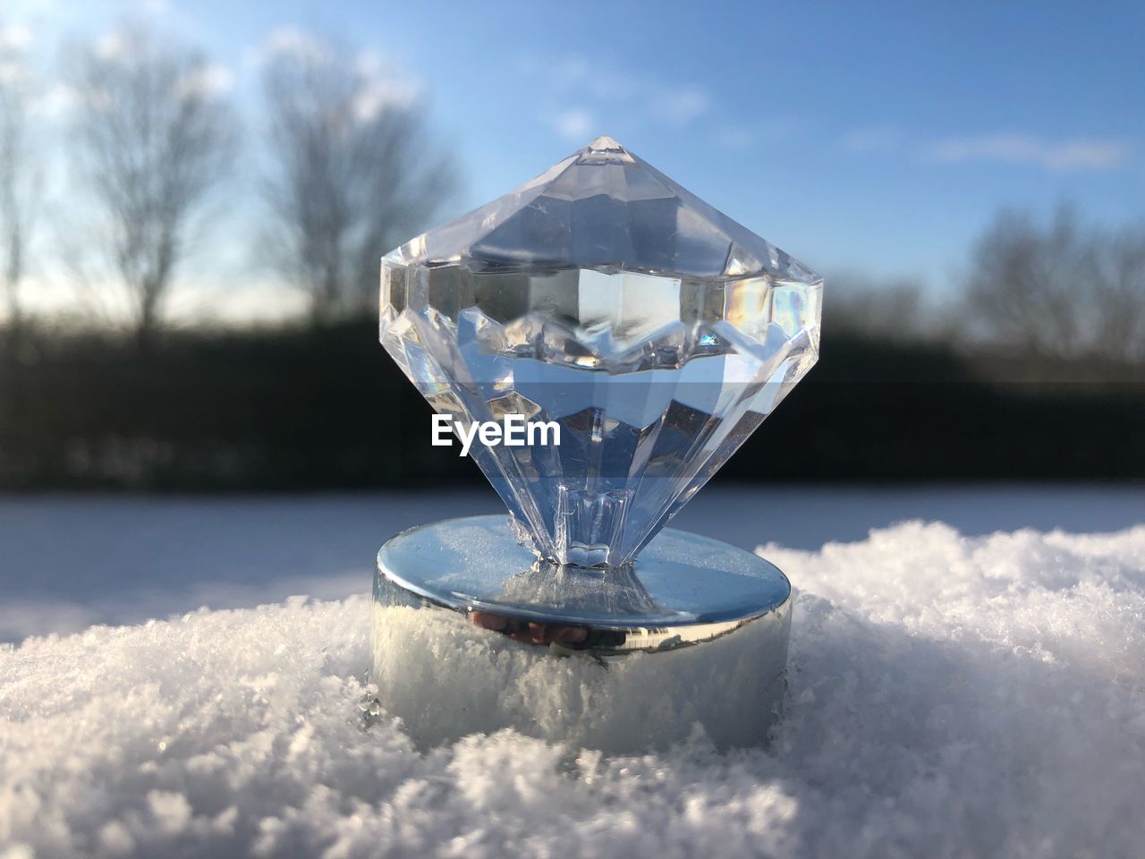 CLOSE-UP OF ICE ON GLASS AGAINST SKY