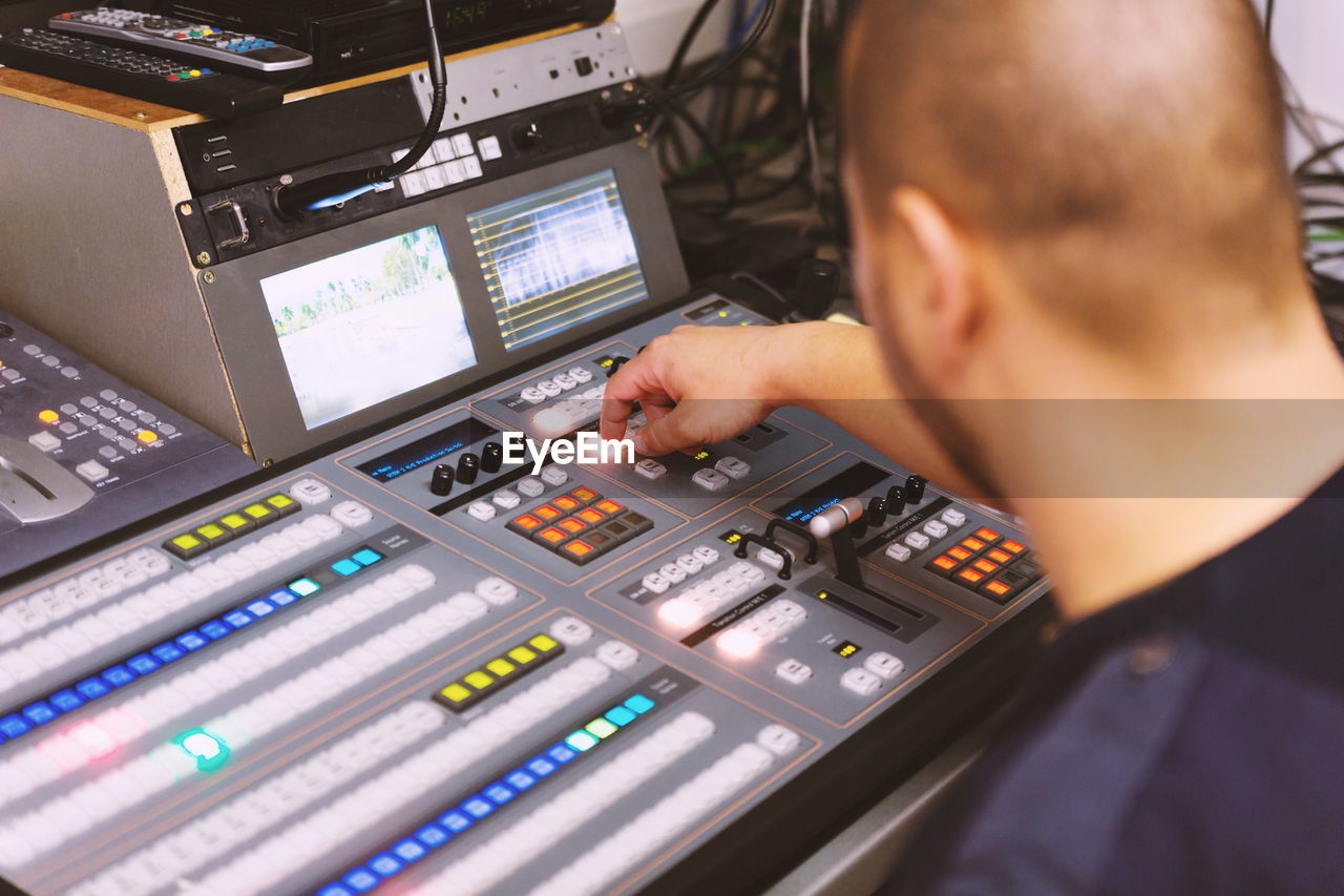 Close-up of man using sound mixer 