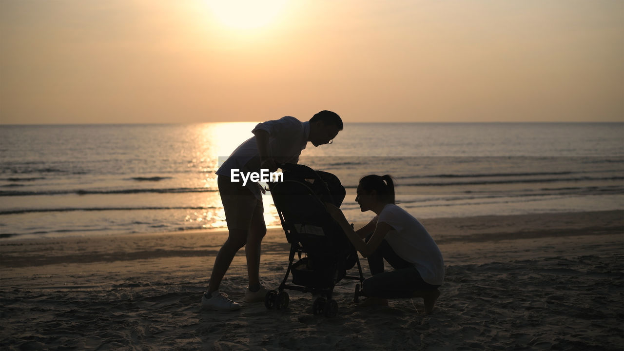 FULL LENGTH OF MEN ON BEACH