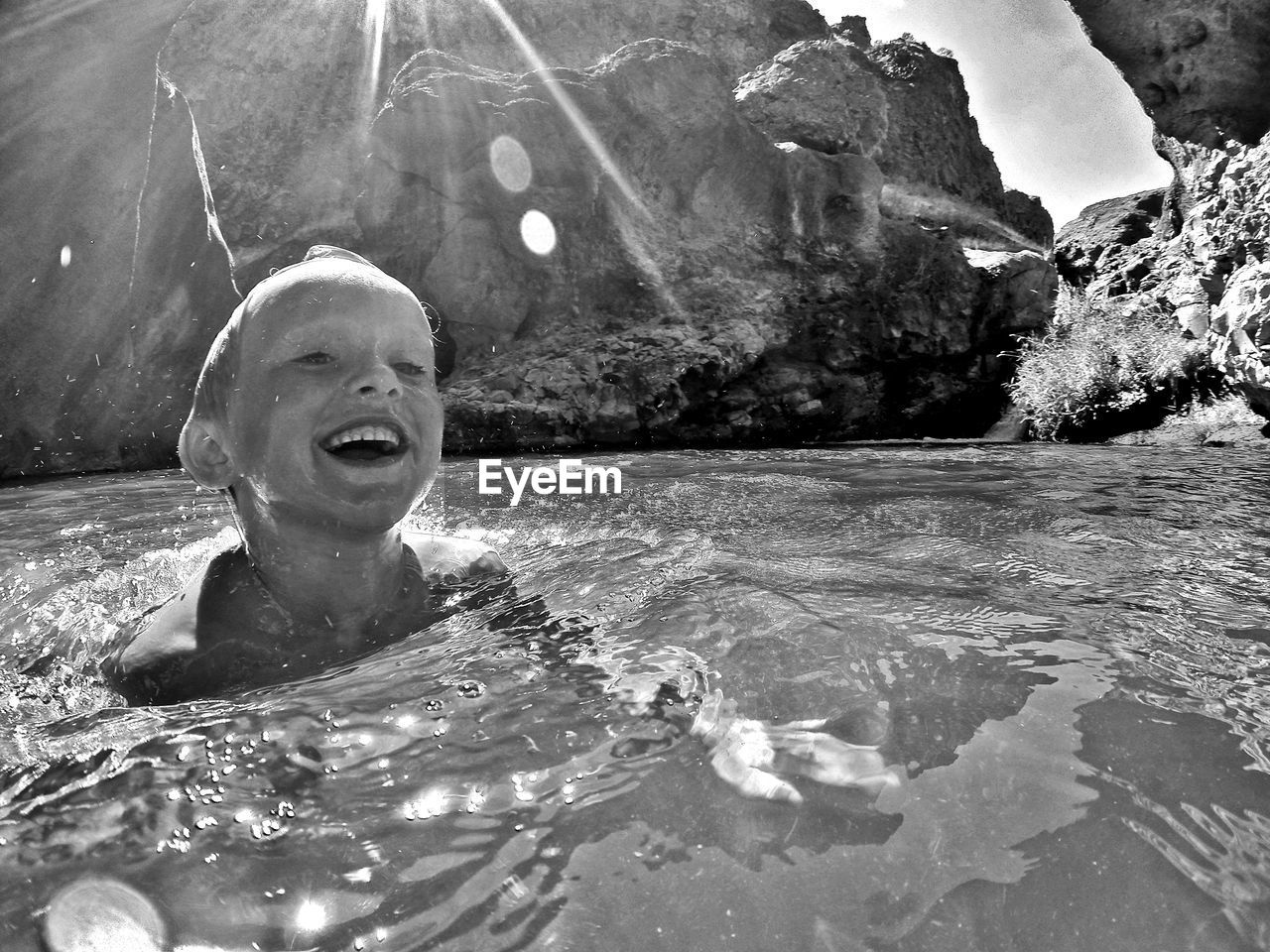 Boy swimming in lake