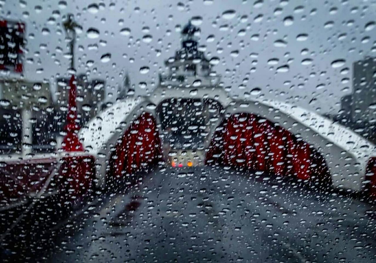 ROAD SEEN THROUGH WET WINDOW