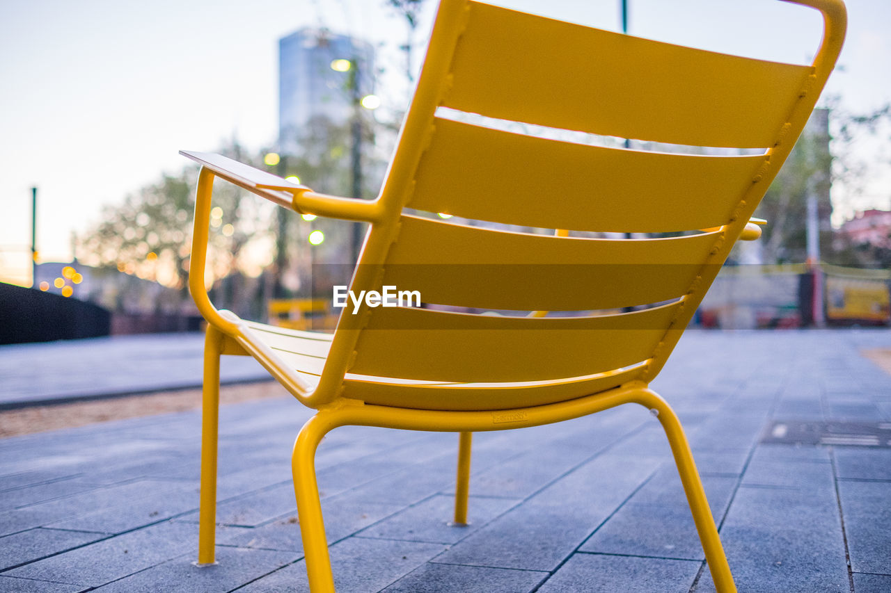 Empty chair on footpath