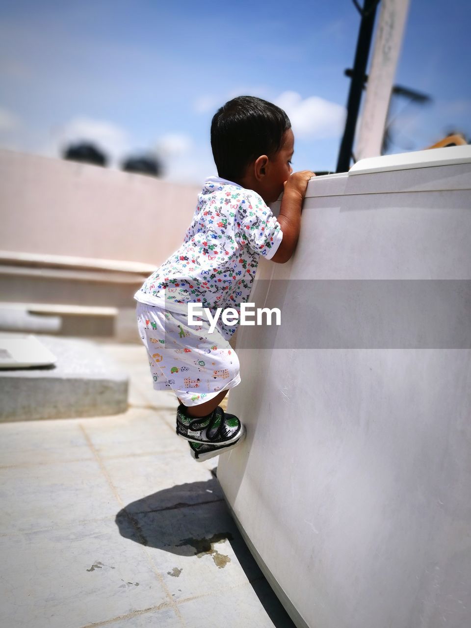 Toddler boy climbing on structure