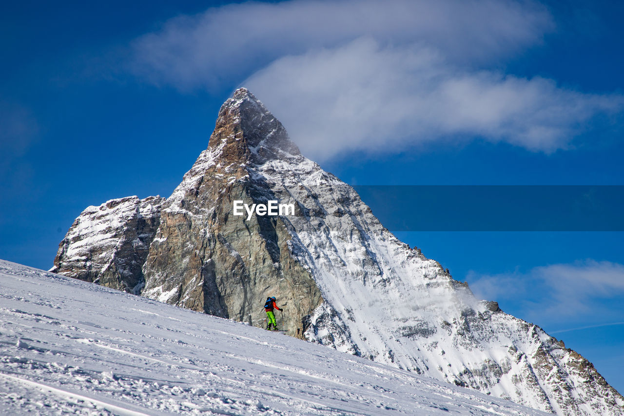 Low angle view of snowcapped mountains against sky