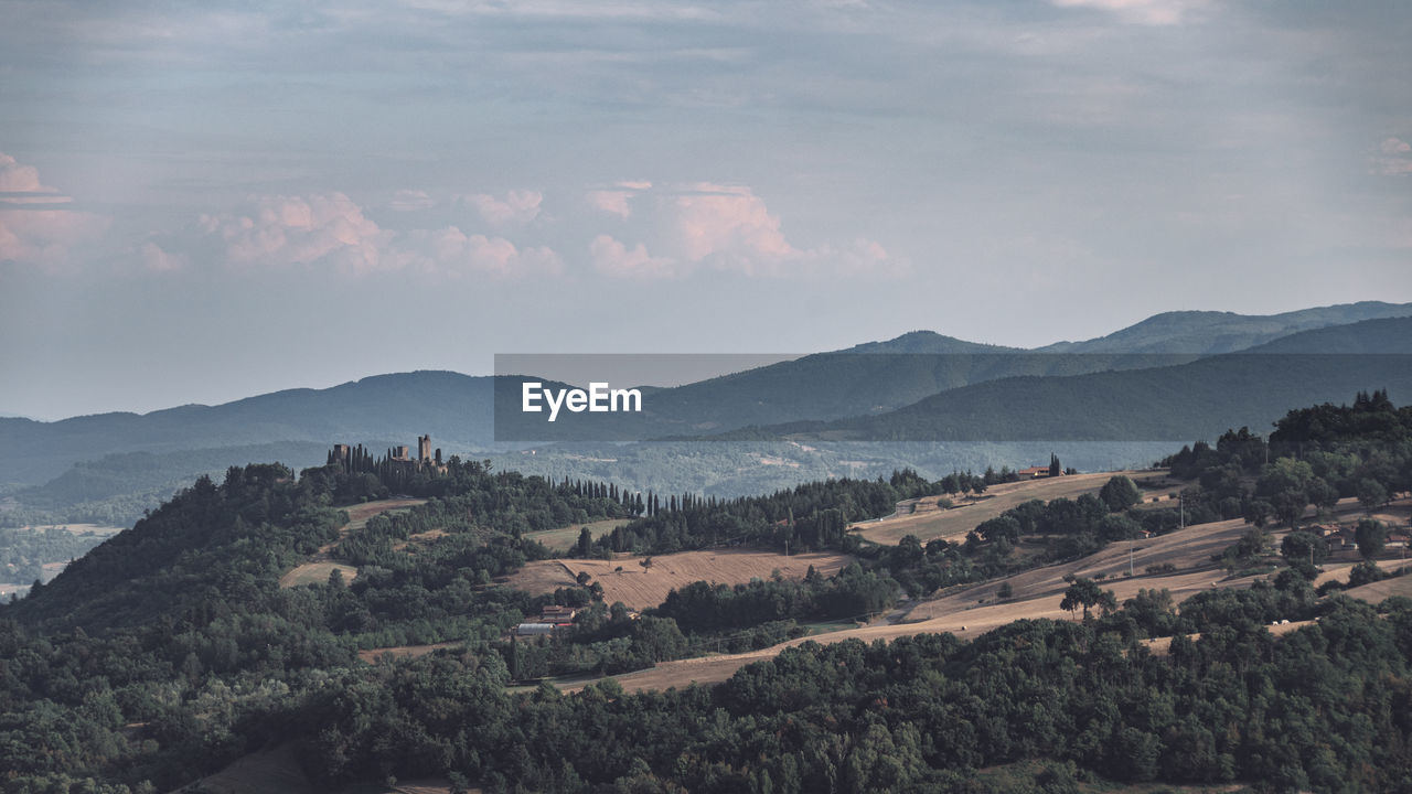 Ruins of an ancient medieval castle at sunset in the tuscan hills