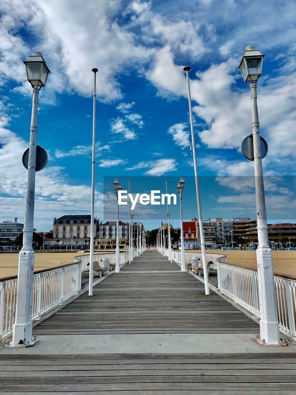 VIEW OF EMPTY BRIDGE AGAINST CLOUDY SKY