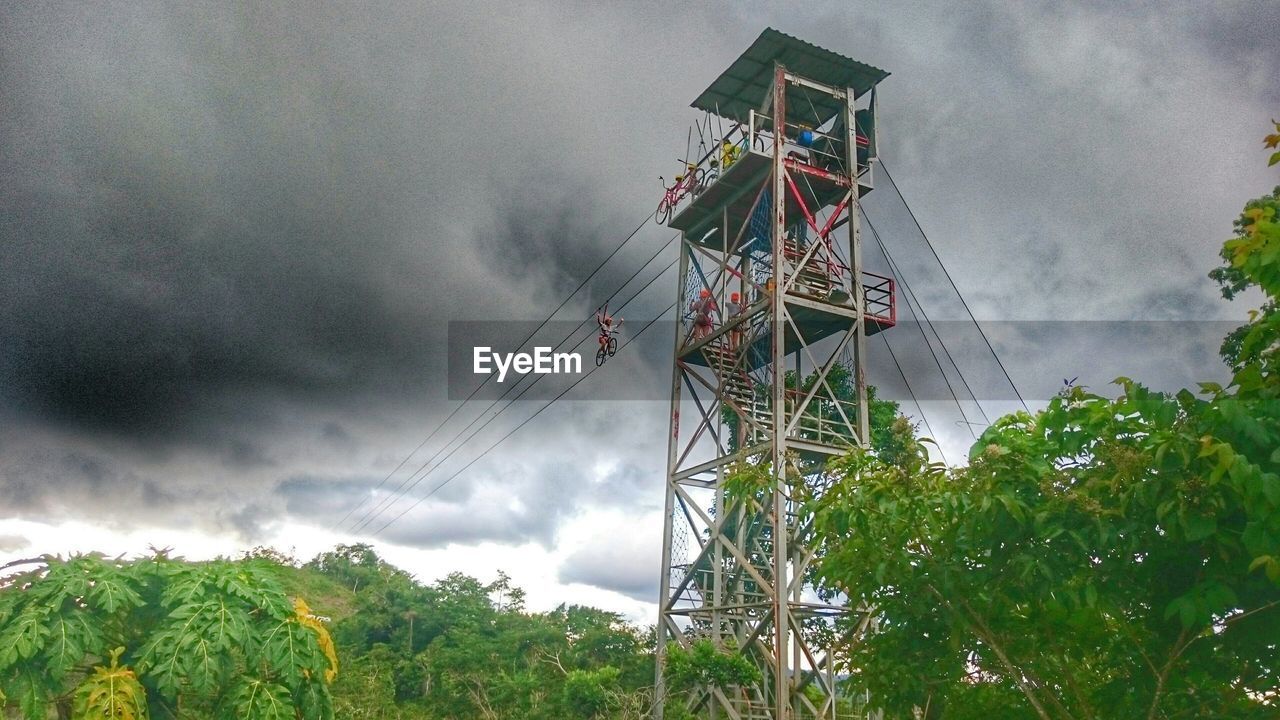 Low angle view of bicycle ride at chocolate hills adventure park against cloudy sky