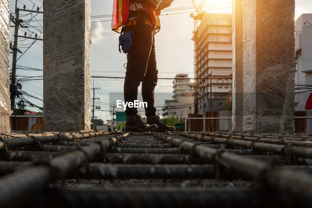 low section of man standing on railroad track