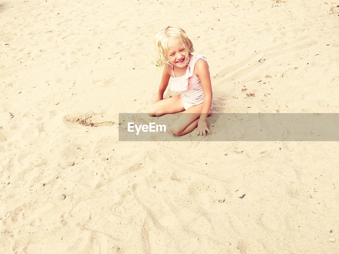 High angle view of happy girl on sandy beach