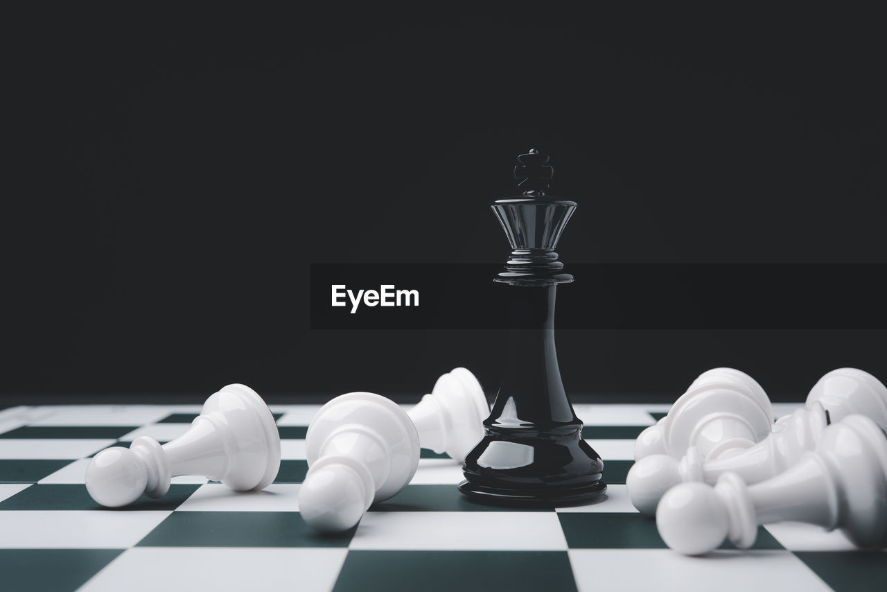 Close-up of chess pieces against black background