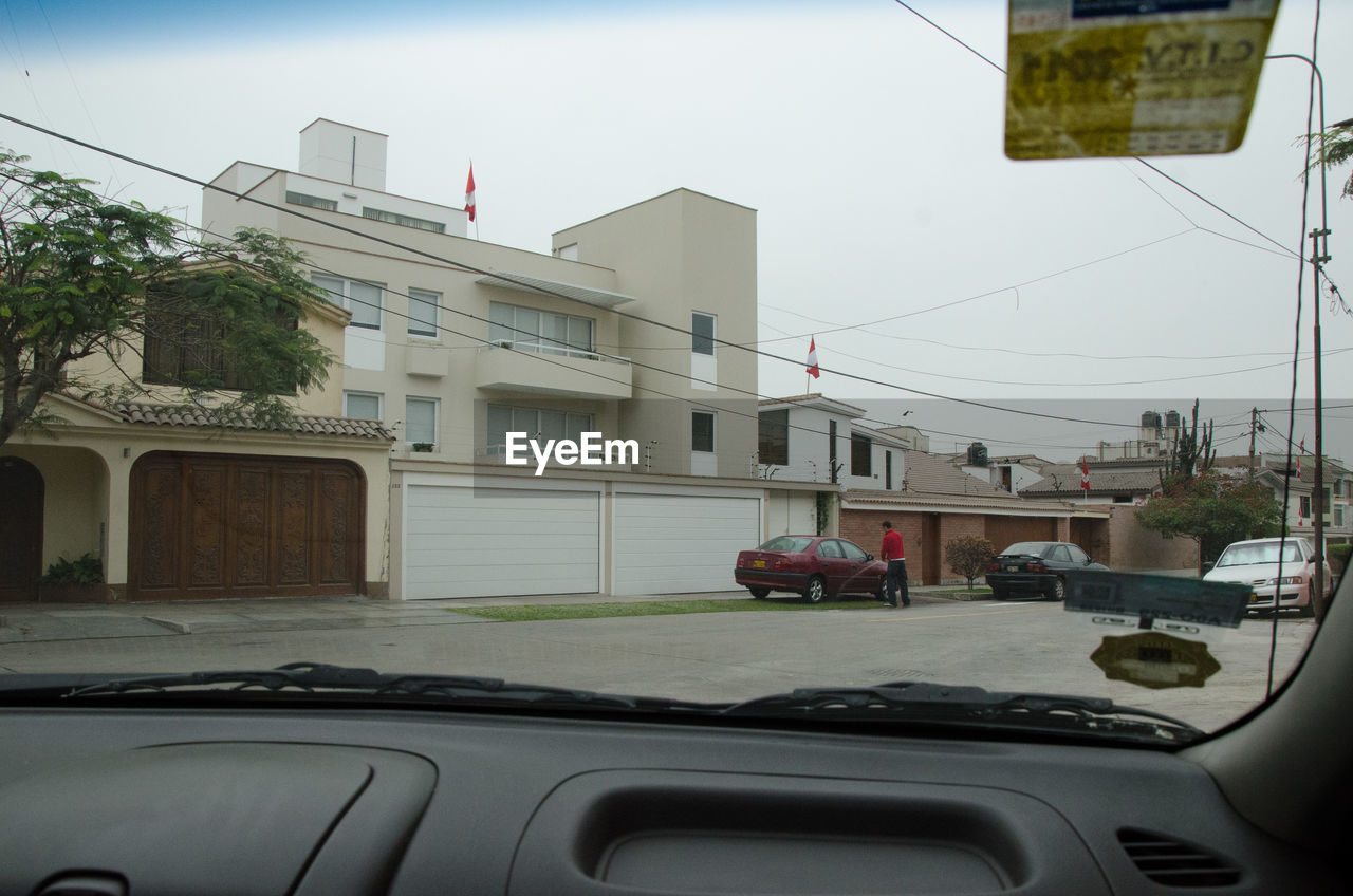 Buildings seen through car windshield