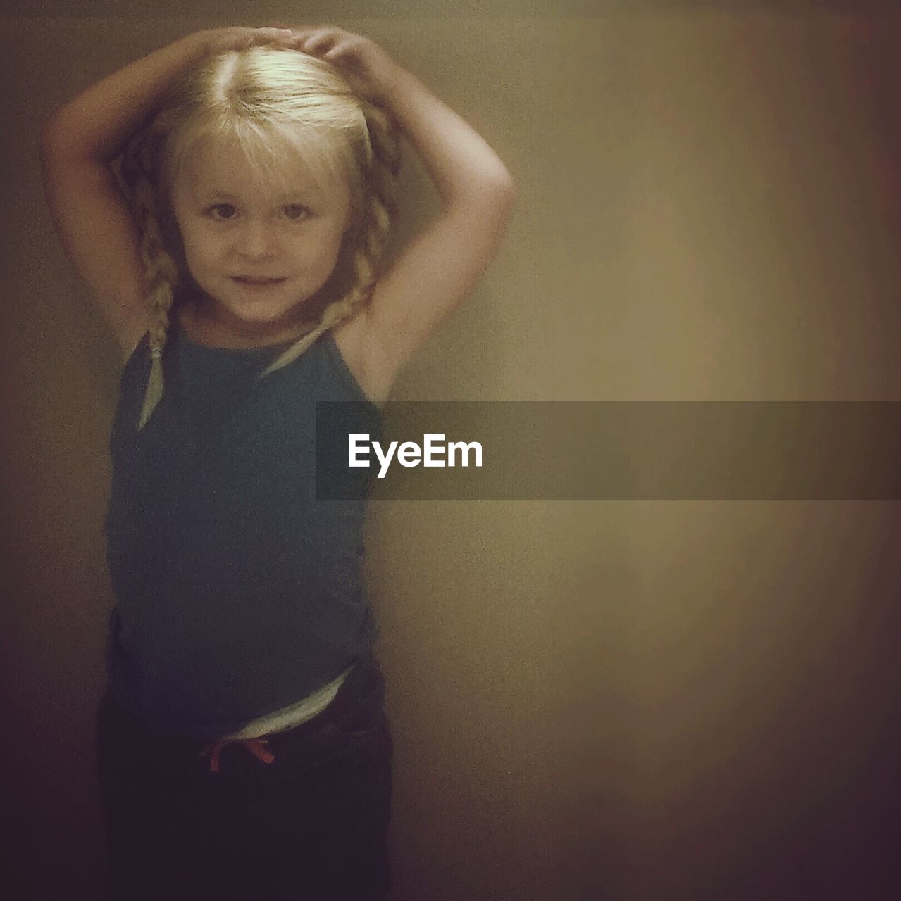 Cute girl standing against wall