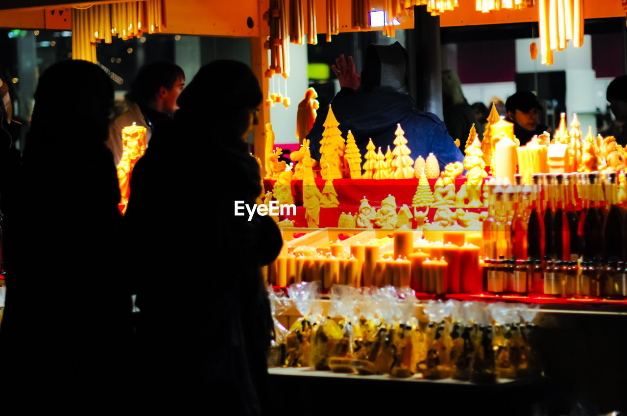 PEOPLE AT ILLUMINATED TEMPLE