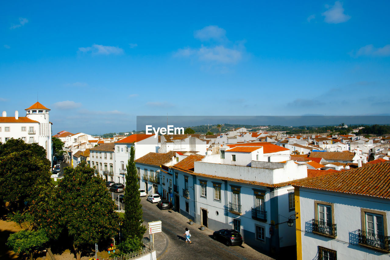 High angle shot of townscape against blue sky