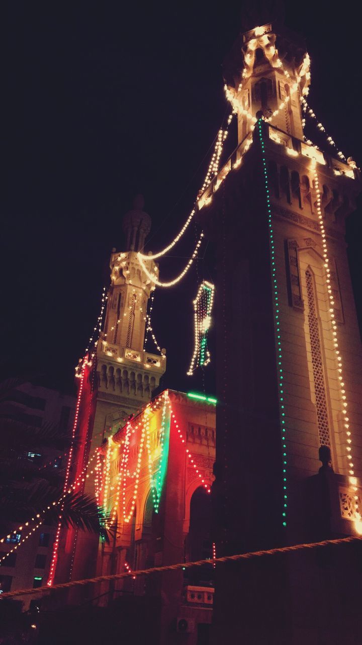 LOW ANGLE VIEW OF ILLUMINATED CITY