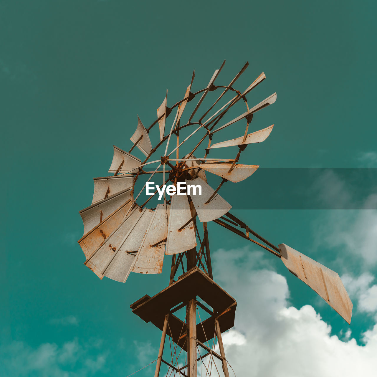 Low angle view of traditional windmill against blue sky