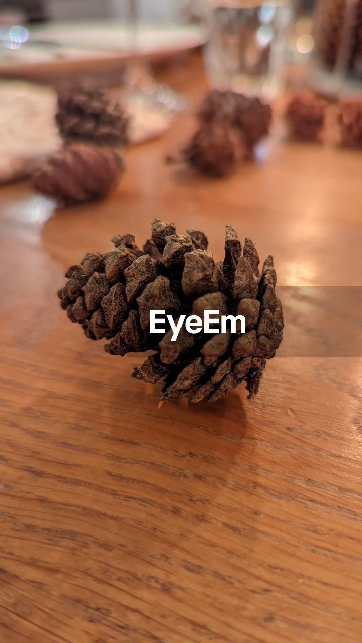 food and drink, food, table, indoors, freshness, wood, no people, wellbeing, close-up, brown, focus on foreground, still life, conifer cone, healthy eating, drink, pine cone