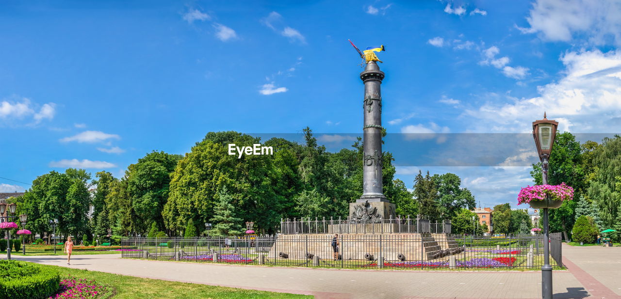 VIEW OF STATUE AGAINST TREES