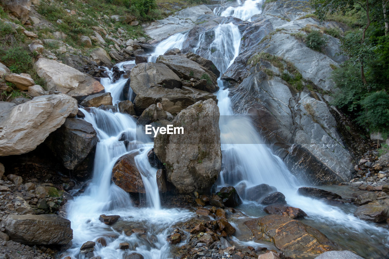 VIEW OF WATERFALL ALONG ROCKS