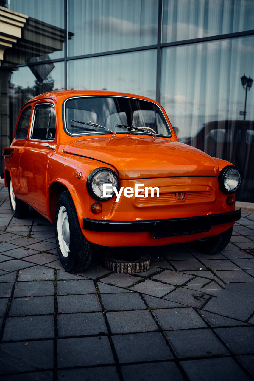 VIEW OF RED CAR ON STREET