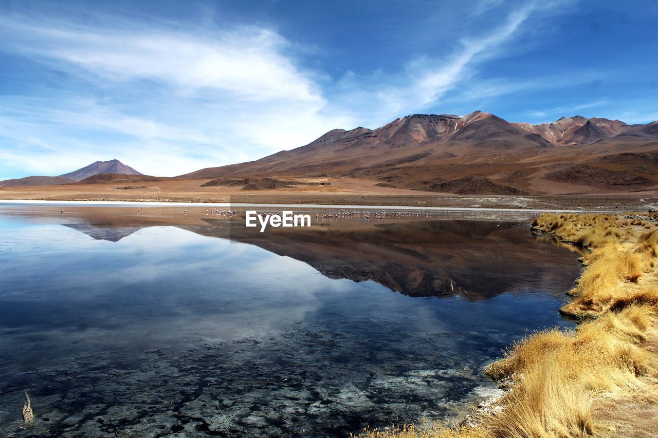 Scenic view of lake and mountains against sky