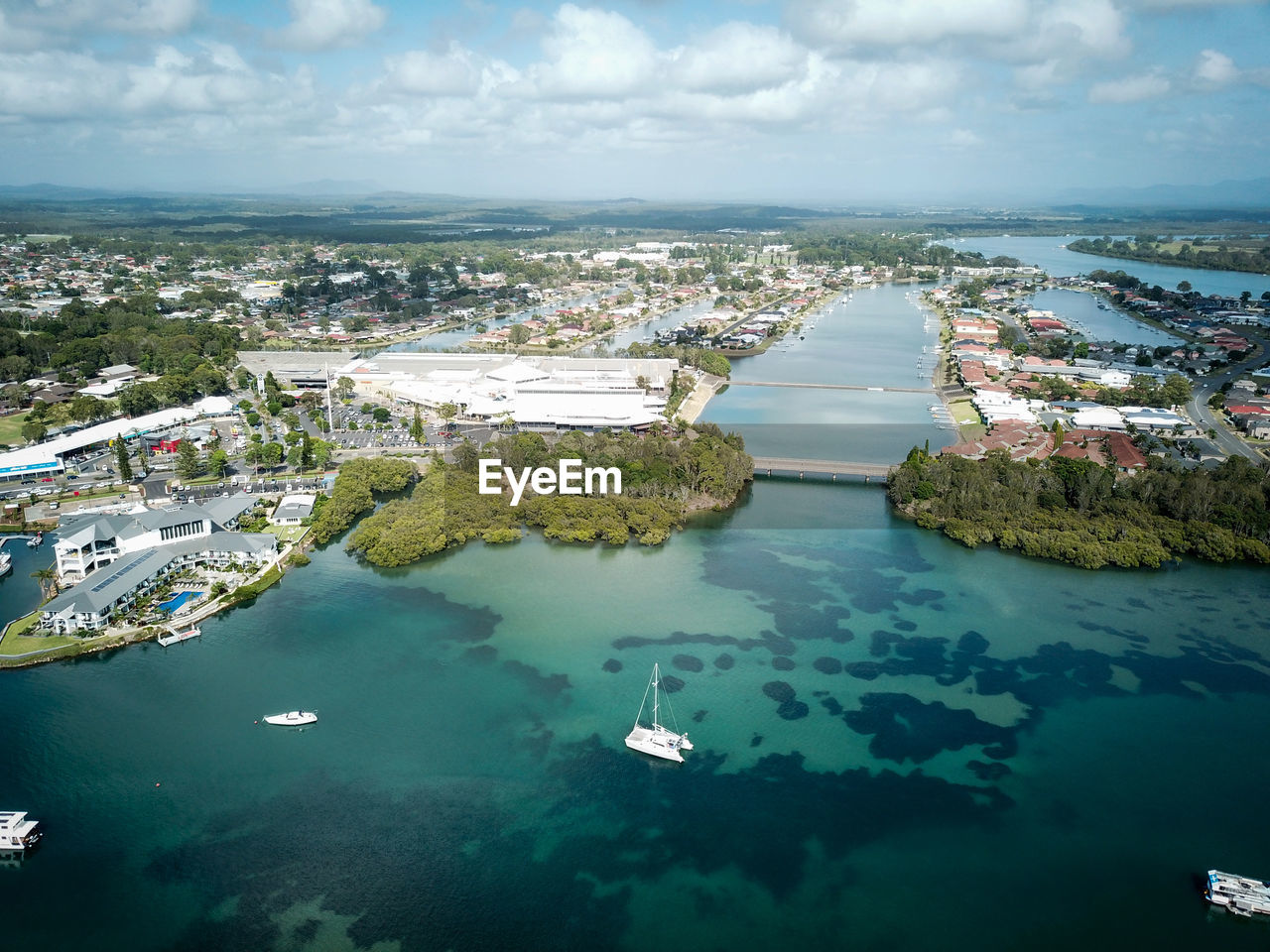 High angle view of buildings by sea against sky