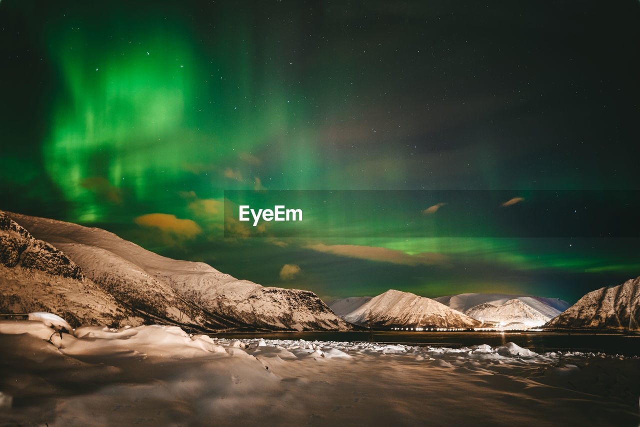 Scenic view of landscape against sky at night during winter