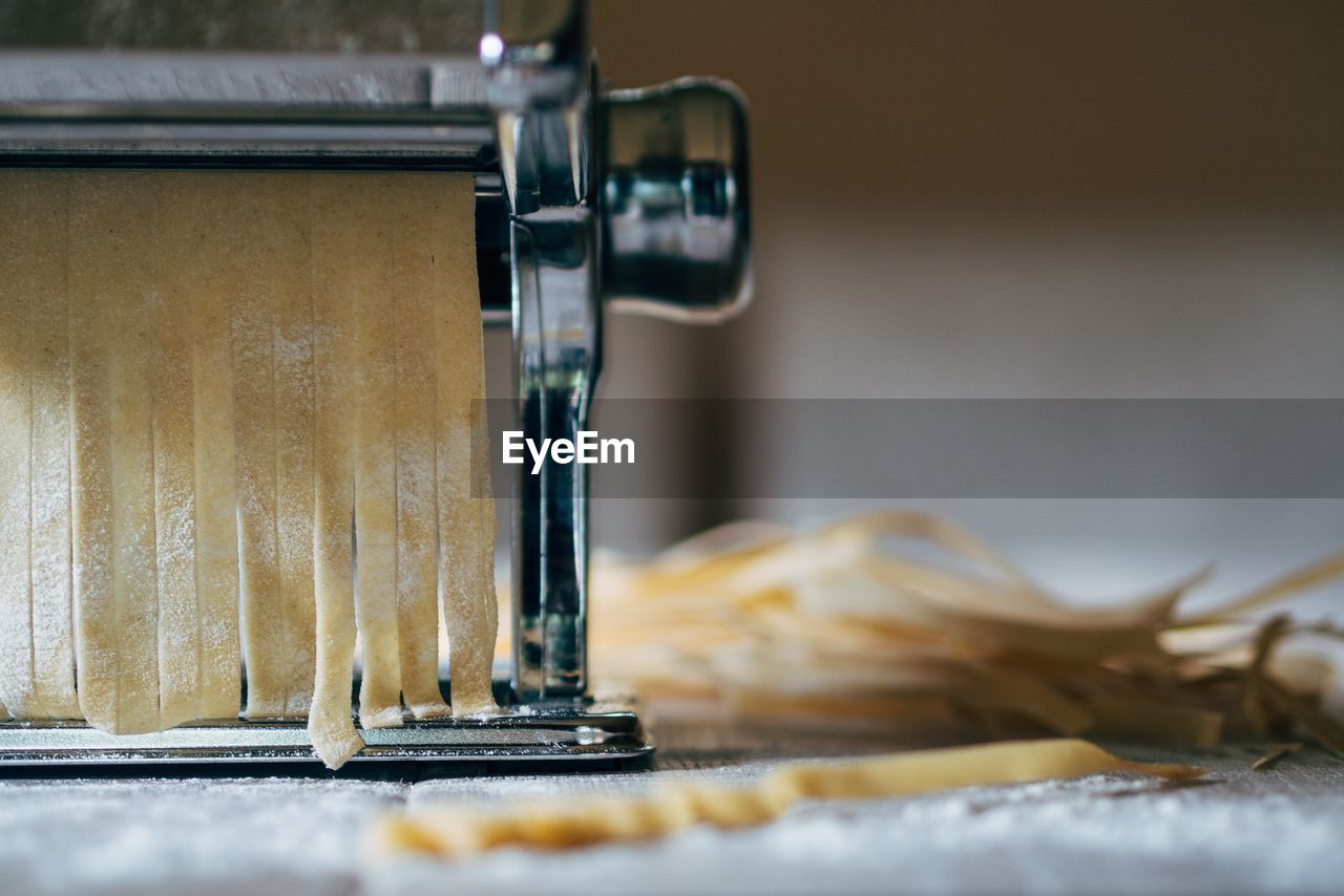 Close-up of pasta maker on table