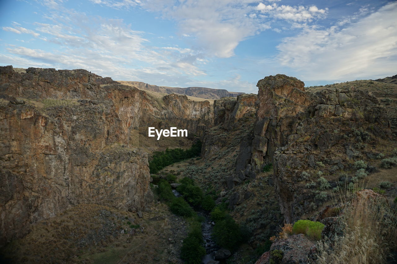 Scenic view of rocky canyon against sky