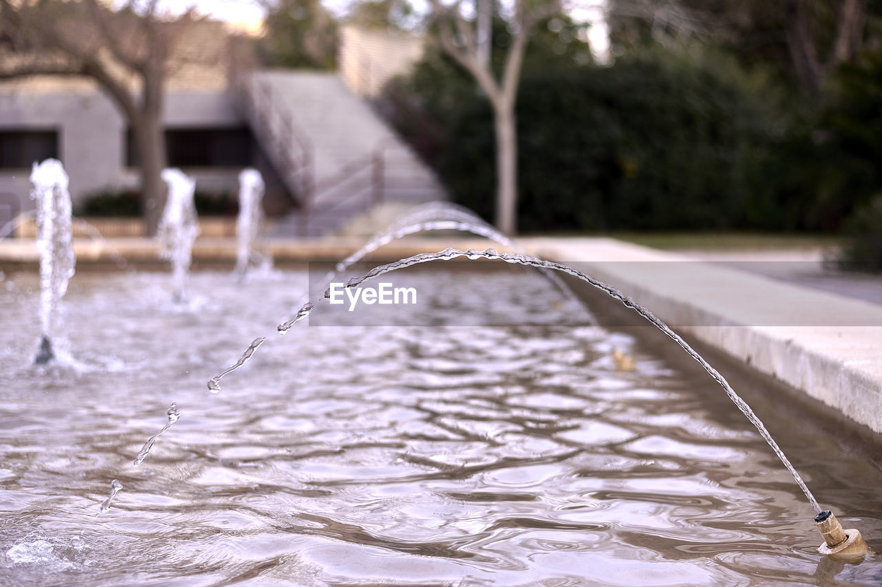 water, winter, nature, snow, tree, motion, freezing, focus on foreground, no people, architecture, day, ice, plant, outdoors, splashing, flowing water, river, built structure, fountain, wet, environment, reflection, water feature