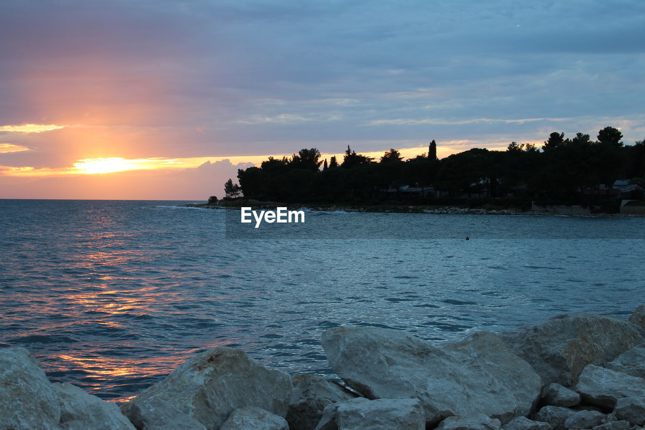 VIEW OF BEACH AGAINST SKY DURING SUNSET