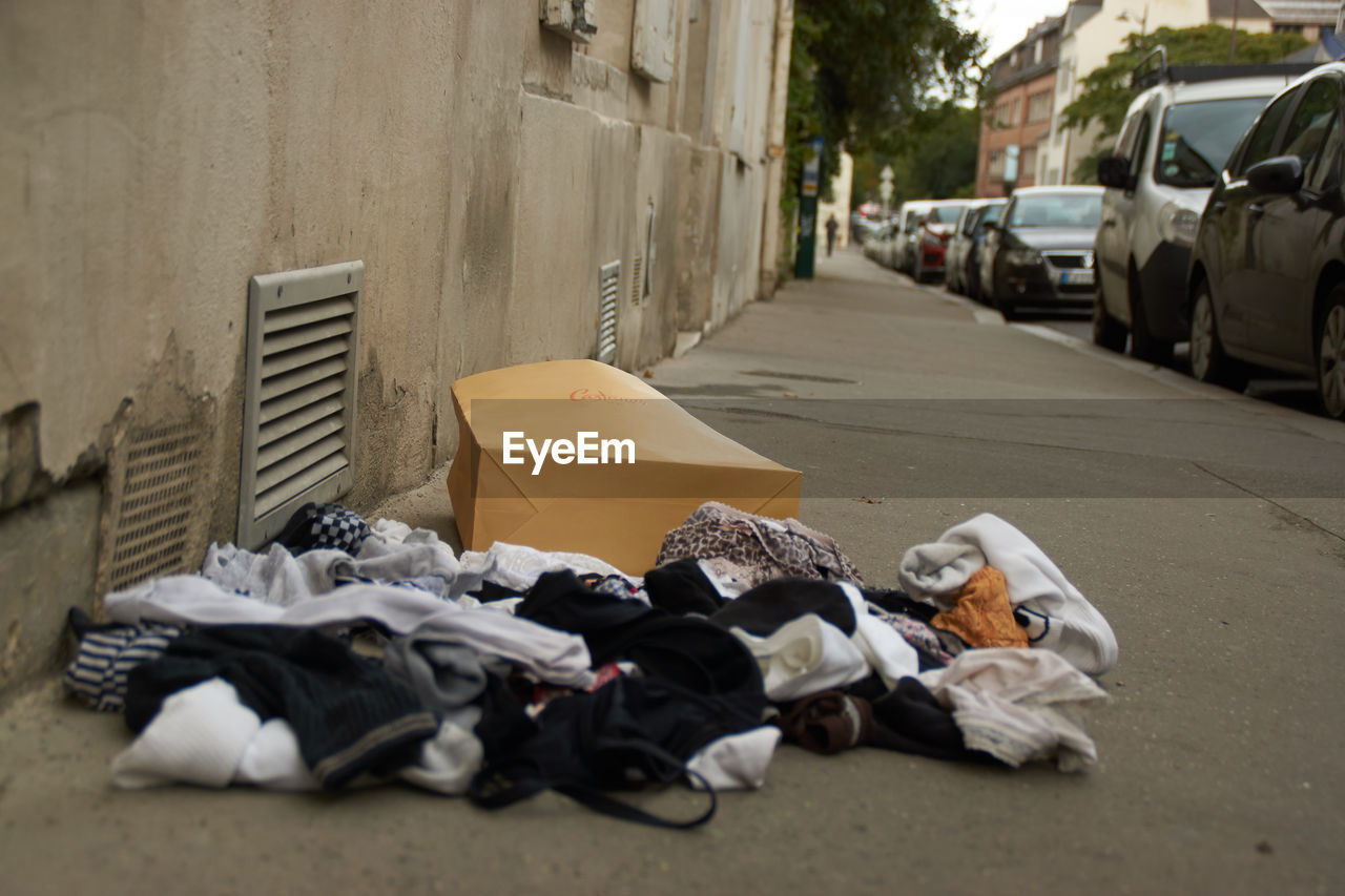 CLOSE-UP OF GARBAGE ON FOOTPATH