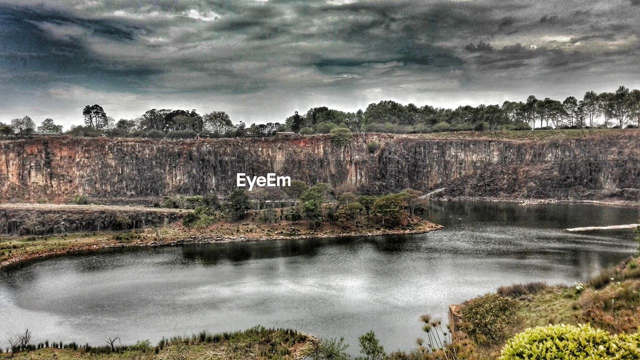 VIEW OF RIVER AGAINST CLOUDY SKY